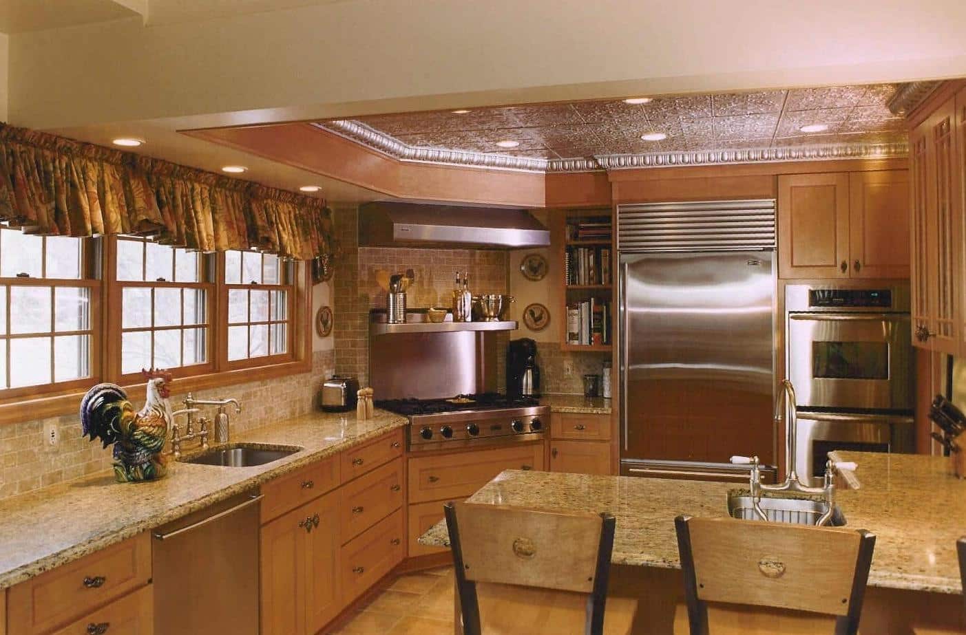 Gibson Design Group Inc. kitchen remodel with custom range and decorative tile backsplash in Metro Detroit.