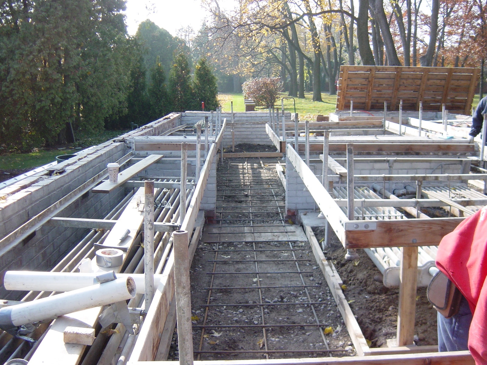 Gibson Design Group Inc. residential construction project with concrete foundation, structural framing, and plumbing installation in Metro Detroit.