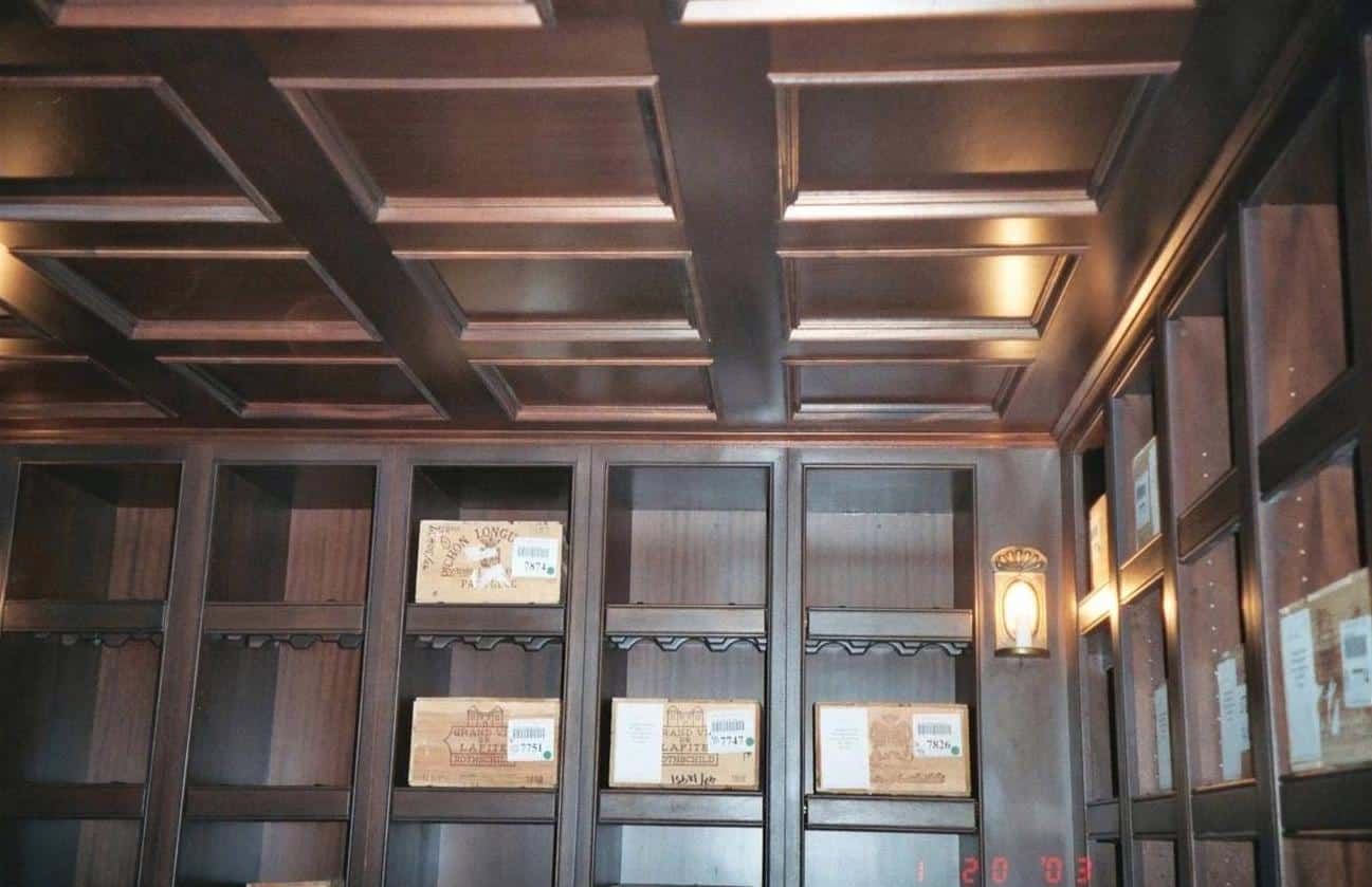 Gibson Design Group Inc. custom wine cellar with coffered ceiling and wood shelving for wine storage in Metro Detroit.